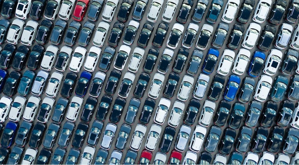 An aerial view of a lot full of cars.