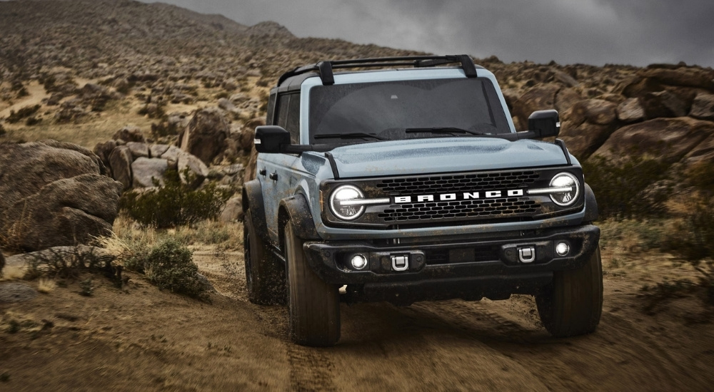 A blue 2021 Ford Bronco off-roading.