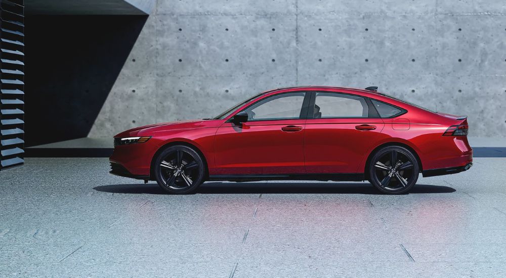 A red 2024 Honda Accord parked outside a building