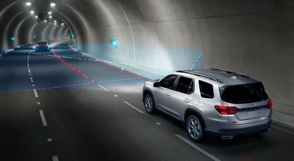 A silver 2025 Honda Pilot Sport safety sensors