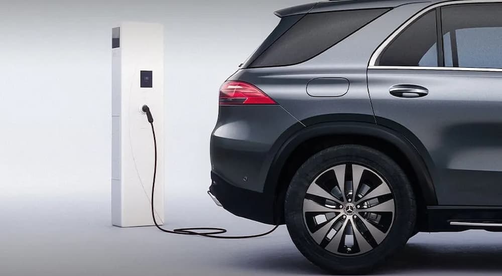 A gray 2025 Mercedes-Benz PHEV plugged in