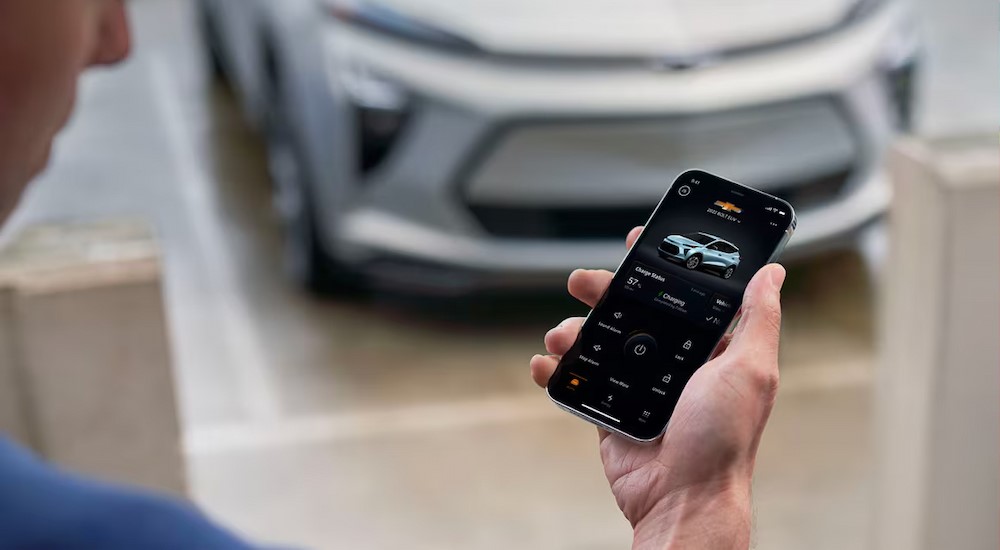 A person using the Chevy App on their cellphone.