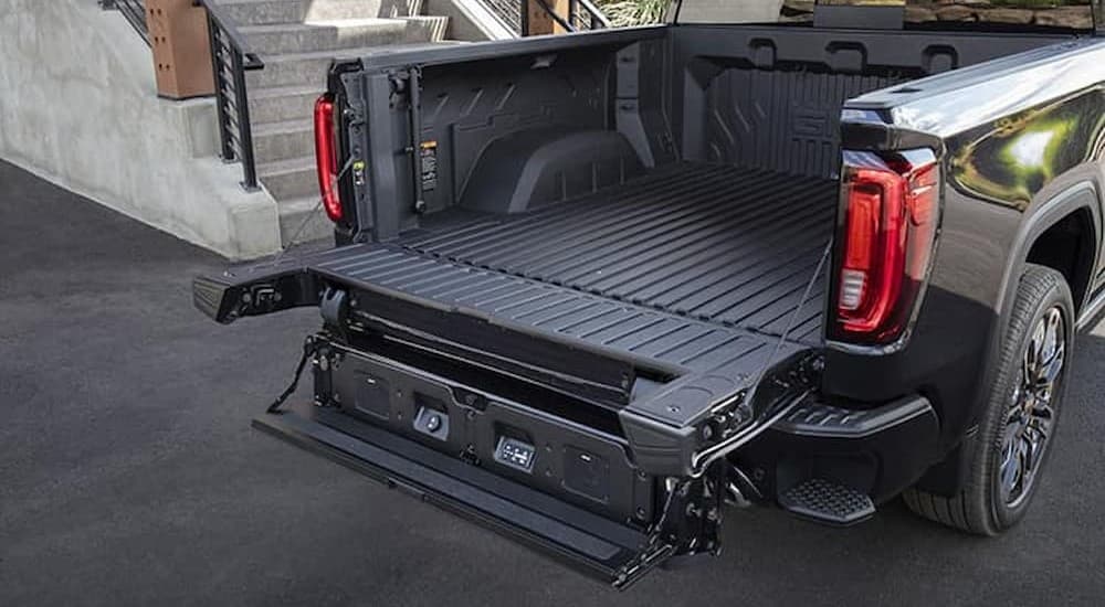 The open tailgate on a black 2025 GMC Sierra for sale.