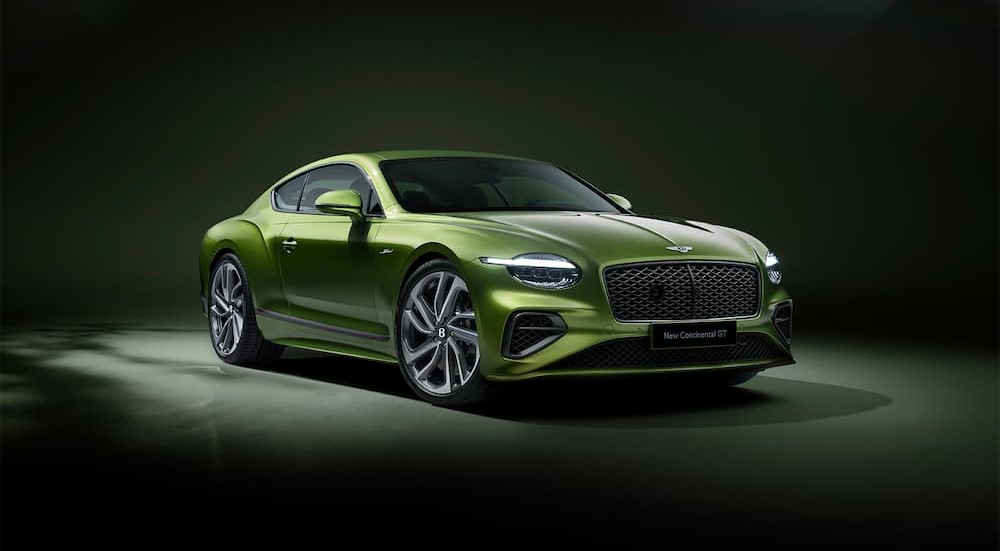 A new green Bentley Continental GT Speed parked in a showroom.