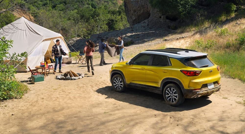 A yellow 2025 Chevy Trailblazer ACTIV parked near a tent.
