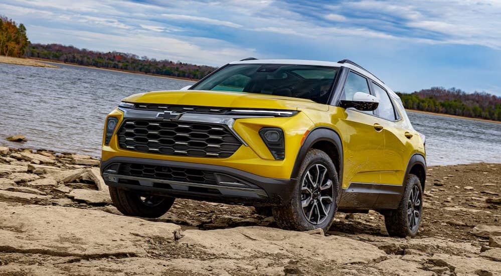 A yellow 2025 Chevy Trailblazer ACTIV parked off-road.