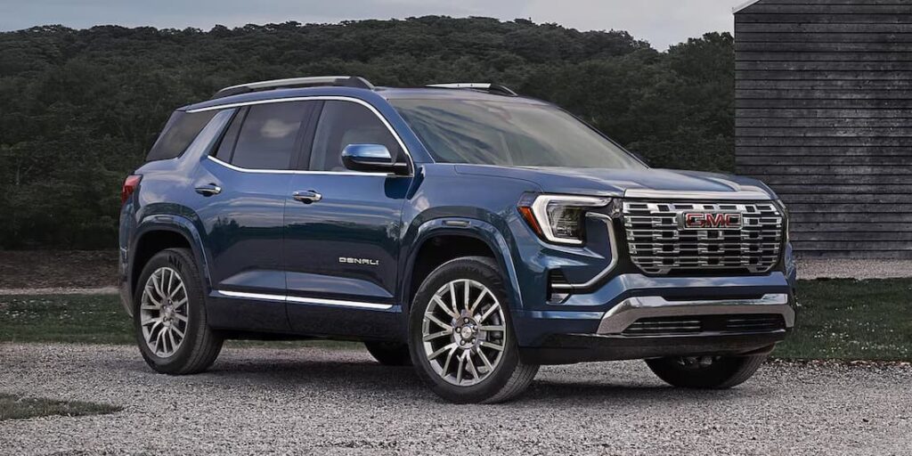 A blue 2026 GMC Terrain Denali parked after visiting a GMC dealer.