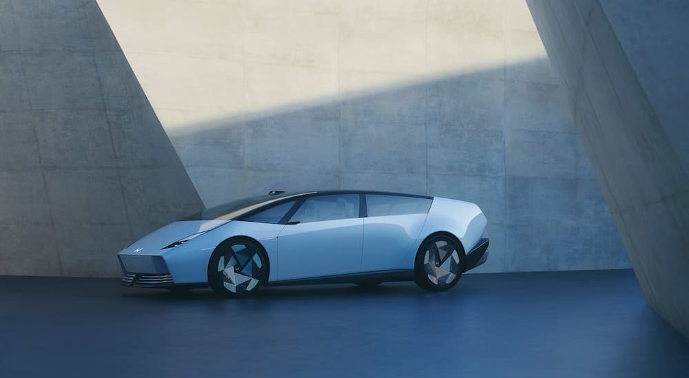 A white Honda 0 SALOON parked in a building.