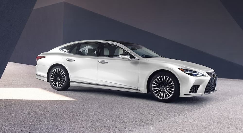 A white 2025 Lexus LS parked in a showroom.