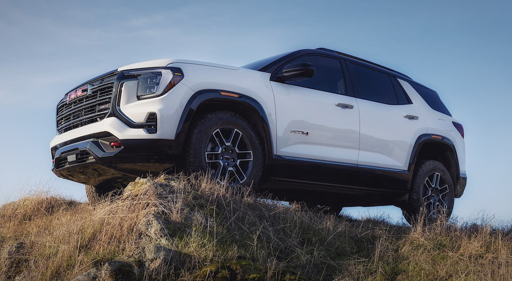 White 2026 GMC Terrain AT4 parked off-road on a hill.