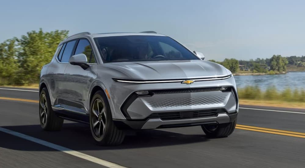 A silver 2025 Chevy Equinox driving on a highway.