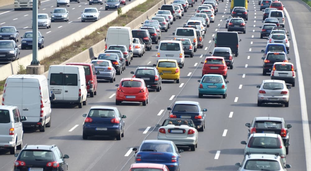 Many cars driving on a highway.
