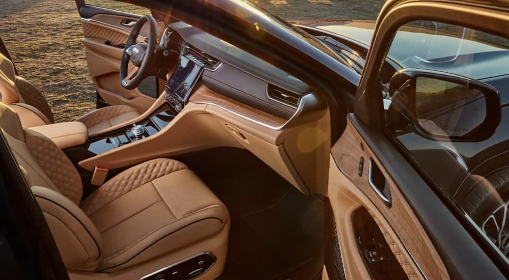 Front tan leather cabin seating in a used 2022 Jeep Grand Cherokee
