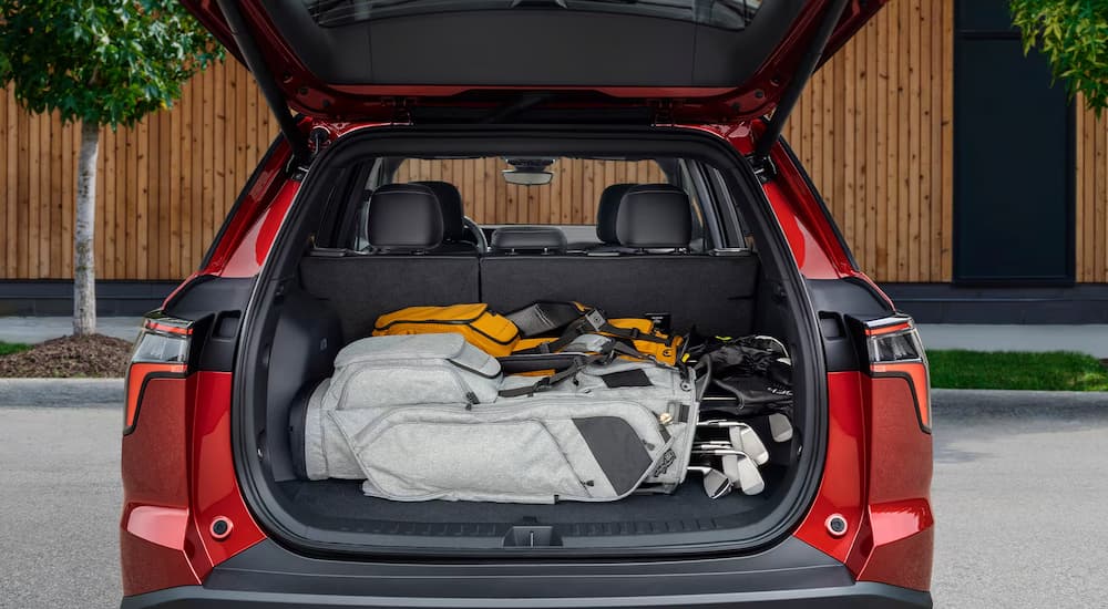 Golfing gear in the back of a red 2026 Chevy Equinox RS