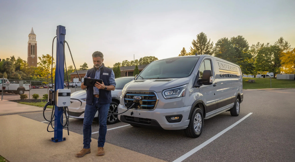 A person charges their Ford E-Transit. 