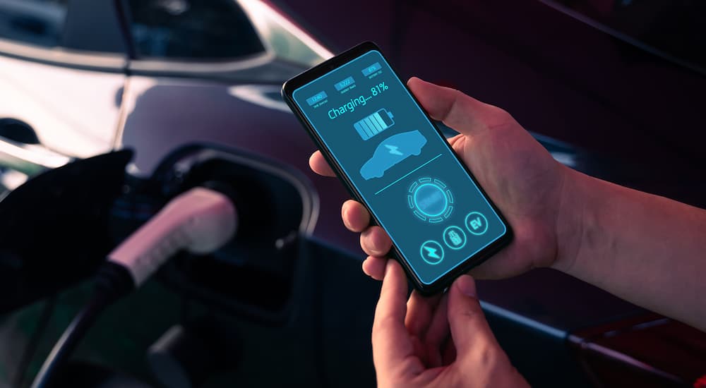 A person using an available app for their EV