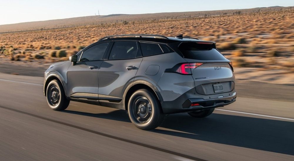 Grey 2026 Sportage X-Pro Prestige driving on a highway