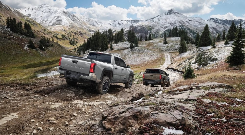 Grey 2025 Toyota Tacoma TRD Off-Road and green Trailhunter off-roading