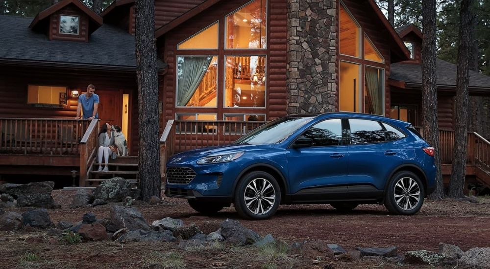 Blue 2022 Ford Escape parked outside of a cabin