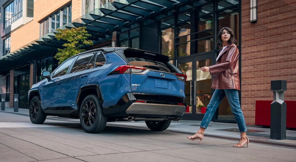 Blue 2022 Toyota RAV4 parked on the side of a city street