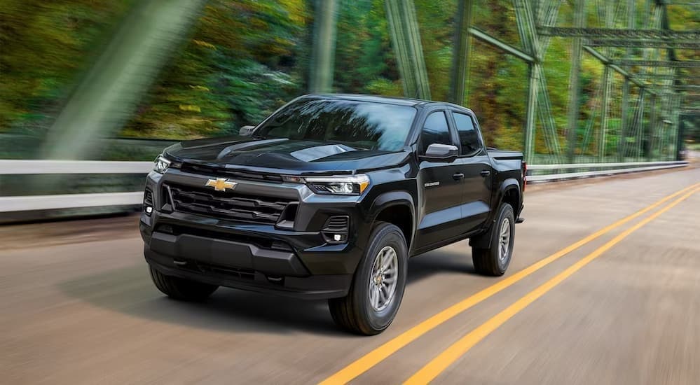 A black 2023 Chevy Colorado driving on a highway.