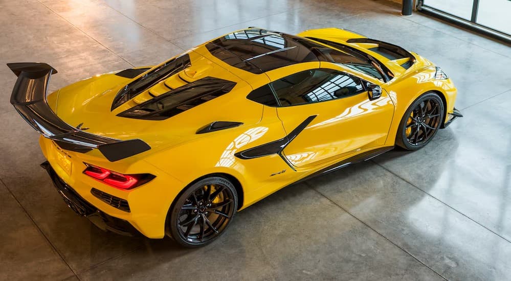 A yellow 2025 Chevy Corvette ZR1 parked in a showroom.