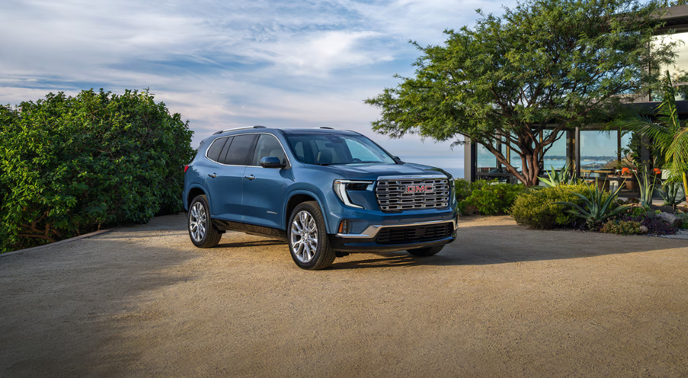 Blue 2026 GMC Acadia parked in front of the ocea
