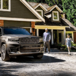 Brown 2026 Jeep Grand Cherokee parked outside a house