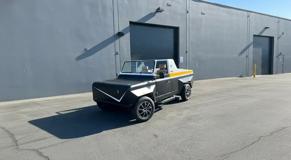 A 2026 Olympian Motors Model 84 parked outside a building