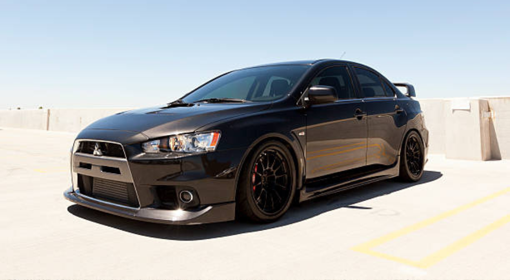 Black 1997 Mitsubishi Lancer Evolution parked at an angle