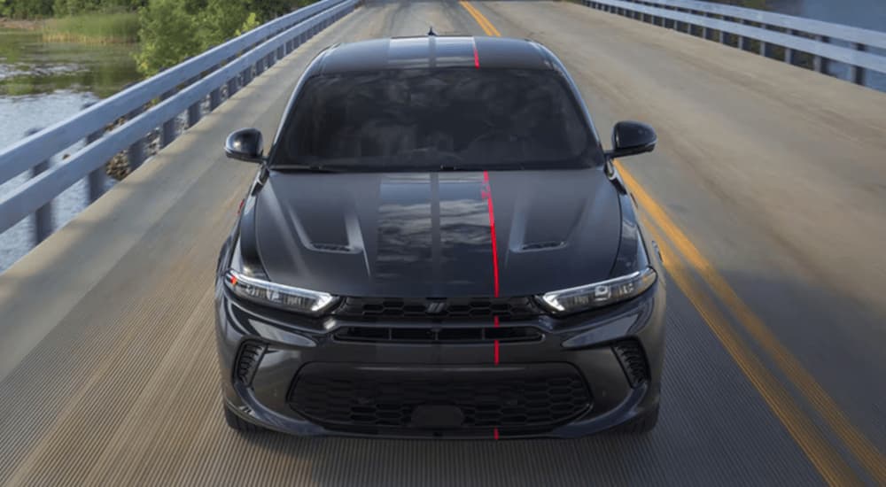 A black 2023 Dodge Hornet driving on a highway