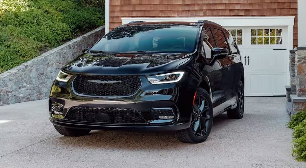 A black 2024 2024 Chrysler Pacifica parked in a driveway