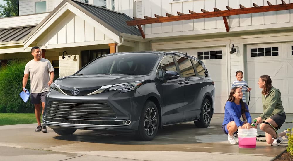 Grey 2026 Toyota Sienna getting washed by a family in the driveway