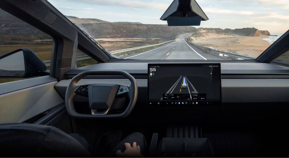 View of a vehicle driving with Full Self Driving along the seacoast while supervised.