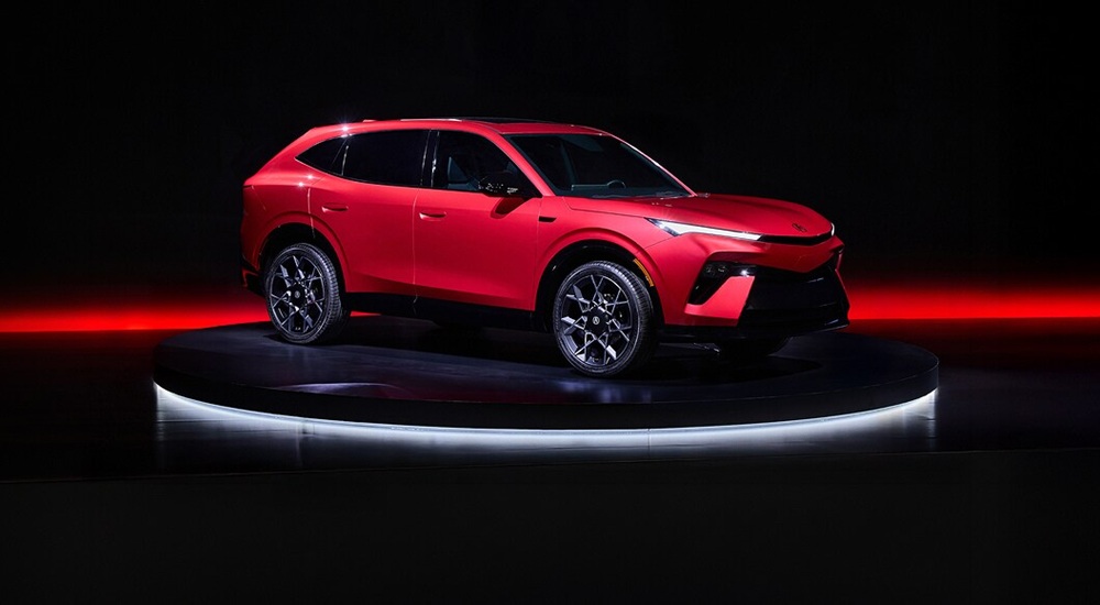 Red 2026 Acura Hybrid angled right.