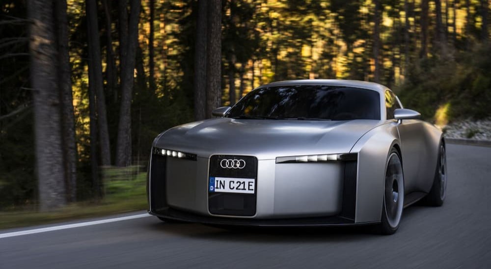 A silver Audi Concept C driving on a highway.