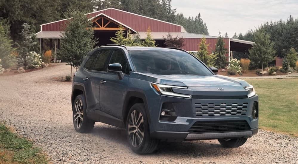 A gray 2026 Toyota RAV4 driving on a farm.